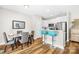 Bright dining area with hardwood floors and modern breakfast bar with blue stools at 5648 Woodard St, Charlotte, NC 28269