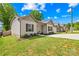 Charming front exterior features a well-manicured lawn and a long driveway at 5648 Woodard St, Charlotte, NC 28269