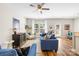 Bright living room featuring hardwood floors, a comfortable blue sofa, and a large window with natural light at 5648 Woodard St, Charlotte, NC 28269