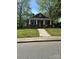 Traditional brick home with a welcoming front porch and well-maintained lawn at 621 Benton St, Monroe, NC 28110