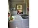 Functional laundry room features a washer, dryer, and shelving for storage at 621 Benton St, Monroe, NC 28110