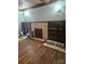 Spacious room with hardwood floors, a brick fireplace, and built-in shelving on both sides at 621 Benton St, Monroe, NC 28110