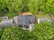 A beautiful aerial view of a home nestled among lush green trees, with a detached garage, and ample yard space at 624 Heather Ln, Charlotte, NC 28209