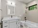 Modern bathroom features black fixtures, sleek white vanity, marble floors, and tiled shower-tub combo at 624 Heather Ln, Charlotte, NC 28209