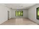 Bright bedroom featuring hardwood floors, ceiling fan, recessed lighting, and three large windows at 624 Heather Ln, Charlotte, NC 28209