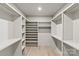 Spacious walk-in closet with custom shelving and wooden floors offer plenty of storage at 624 Heather Ln, Charlotte, NC 28209