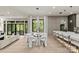Elegant dining area flows into the living room, showcasing a modern table and chairs with backyard views at 624 Heather Ln, Charlotte, NC 28209