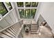 Bright entryway with a staircase, hardwood floors, iron railings and multiple large windows at 624 Heather Ln, Charlotte, NC 28209