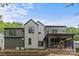 Contemporary home with a covered patio, sleek siding, and a well-maintained retaining wall at 624 Heather Ln, Charlotte, NC 28209