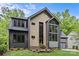 Contemporary home featuring a modern design, manicured lawn, and striking architectural details at 624 Heather Ln, Charlotte, NC 28209