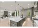 Bright, modern kitchen boasts a large island with seating and pendant lighting, connecting to the living area at 624 Heather Ln, Charlotte, NC 28209