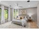 Bright main bedroom boasts large windows, ceiling fan, recessed lighting, and neutral decor at 624 Heather Ln, Charlotte, NC 28209