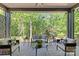 Covered patio with comfortable outdoor seating surrounded by lush greenery at 624 Heather Ln, Charlotte, NC 28209