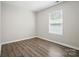 Bedroom with one window, base molding, and wood-look floors at 6430 Matlea Ct, Charlotte, NC 28215