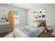 Bedroom decorated with a surfboard, modern artwork, and contemporary furniture at 6430 Matlea Ct, Charlotte, NC 28215