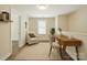 This bonus room includes a cozy sitting area, desk, and lots of natural light at 6430 Matlea Ct, Charlotte, NC 28215