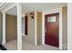 Inviting front porch featuring a brick-red door with glass accents and white columns at 6430 Matlea Ct, Charlotte, NC 28215