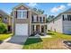 Charming home with neutral siding, red shutters, manicured lawn, and single car garage at 6430 Matlea Ct, Charlotte, NC 28215