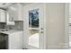 A kitchen with white cabinetry, stainless steel appliances, and a view to the backyard at 6430 Matlea Ct, Charlotte, NC 28215
