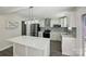 Stylish kitchen featuring white cabinets, quartz countertops, stainless steel appliances, and an island at 6430 Matlea Ct, Charlotte, NC 28215