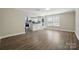 Spacious living room with wood-look flooring and large windows offering ample natural light at 6430 Matlea Ct, Charlotte, NC 28215