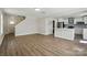 Open floor plan with a kitchen featuring a kitchen island and wood floors throughout the house at 6430 Matlea Ct, Charlotte, NC 28215
