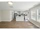 Open-concept living space connecting to a kitchen with white cabinets and stainless steel appliances at 6430 Matlea Ct, Charlotte, NC 28215