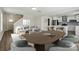 The staged living area includes a dining area and comfortable sofa, flowing into the modern kitchen at 6430 Matlea Ct, Charlotte, NC 28215