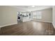 Open-concept living area showcasing wood-look floors and seamless flow into the kitchen space at 6430 Matlea Ct, Charlotte, NC 28215