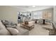 Open-concept living space featuring a comfortable sofa and dining area, open to a modern kitchen at 6430 Matlea Ct, Charlotte, NC 28215