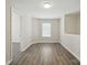 An airy room with luxury vinyl plank flooring, and a window letting in natural light at 6430 Matlea Ct, Charlotte, NC 28215