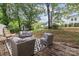 A cozy back deck with outdoor seating area overlooking a green lawn and wooded area at 6719 Woodshed Cir, Charlotte, NC 28270