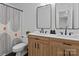 Bathroom with dual sinks, wood vanity, and modern fixtures, plus a shower tub combo at 6719 Woodshed Cir, Charlotte, NC 28270