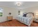 Comfortable bedroom with natural light, decorative lighting fixture, and neutral colored decor at 6719 Woodshed Cir, Charlotte, NC 28270