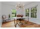 Dining room with modern chandelier, hardwood floors, and natural light at 6719 Woodshed Cir, Charlotte, NC 28270