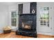 Close up of the living room fireplace featuring black rockwork and an adjacent exit to the outside at 6719 Woodshed Cir, Charlotte, NC 28270