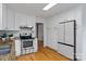 Bright kitchen with stainless steel appliances, granite countertops, and ample white cabinet storage at 6719 Woodshed Cir, Charlotte, NC 28270