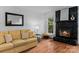 Living room featuring a fireplace with stonework and views of the landscaped exterior at 6719 Woodshed Cir, Charlotte, NC 28270