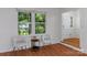 Bright living room with light colored walls, hardwood floors, and a pair of chairs at 6719 Woodshed Cir, Charlotte, NC 28270
