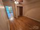 Bedroom with wood-look flooring, neutral walls, and an open closet provides a versatile space at 6813 Navajo Trl, Sherrills Ford, NC 28673