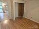 Bedroom with wood-look flooring, neutral walls, and an open closet provides a versatile space at 6813 Navajo Trl, Sherrills Ford, NC 28673