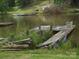 Scenic view of weathered dock on calm lake surrounded by lush green trees at 6813 Navajo Trl, Sherrills Ford, NC 28673