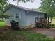 A view of the exterior of the home with light blue siding, and a small porch at 6813 Navajo Trl, Sherrills Ford, NC 28673