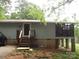 Exterior of home with stairs leading to the front door and a screened-in porch area at 6813 Navajo Trl, Sherrills Ford, NC 28673