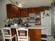 Functional kitchen featuring wood cabinets, a white countertop, and standard appliances at 6813 Navajo Trl, Sherrills Ford, NC 28673