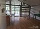 Open-concept living area with wood floors and large windows at 6813 Navajo Trl, Sherrills Ford, NC 28673