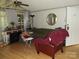 Comfortable living room featuring a ceiling fan, wood-look flooring, and a red armchair at 6813 Navajo Trl, Sherrills Ford, NC 28673