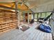 Spacious sunroom with natural light, painted wood flooring, and a view to a kitchen at 6813 Navajo Trl, Sherrills Ford, NC 28673