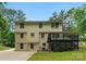 Back of home features a deck, a patio underneath and a spacious driveway at 7016 Wannamaker Ln, Charlotte, NC 28226