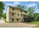 Back of home features a deck, a patio underneath and a spacious driveway at 7016 Wannamaker Ln, Charlotte, NC 28226